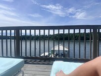 View from comfy lounge chairs overlooking dock and lake!