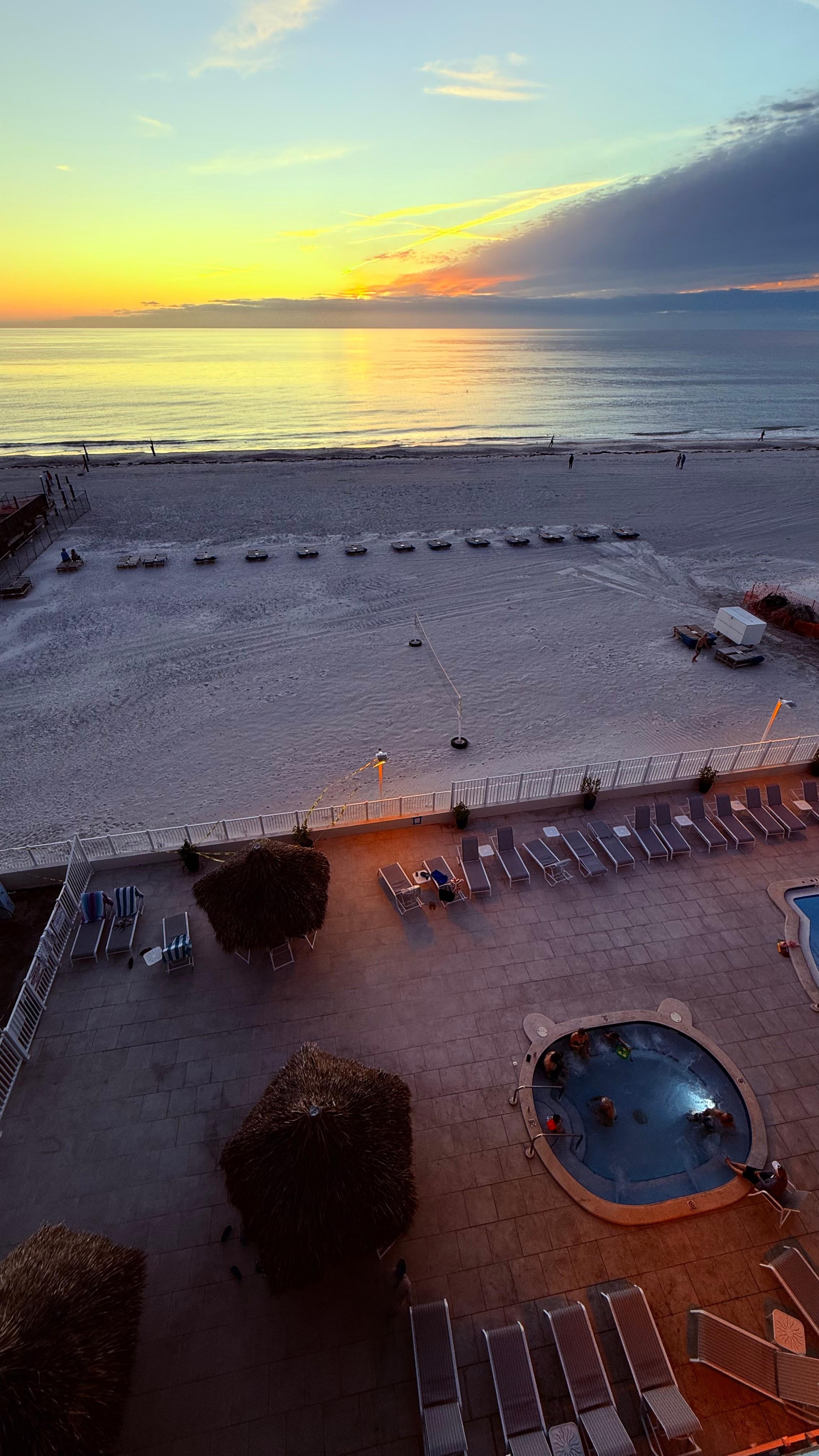Looking down from the deck at the hot tub and beach