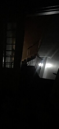 Dark lobby with glaring light down to apartment