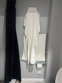 The bathroom in the one bedroom with the towels not changed.