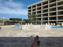 Clean and well-maintained pool area and hot tub.