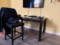 The only table and chair in the room, note the chairs bar height and you wouldn’t be able to sit facing the table with this chair.