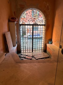 You enter from the little square with the supermarket and go through this sculpture lobby right on the canal