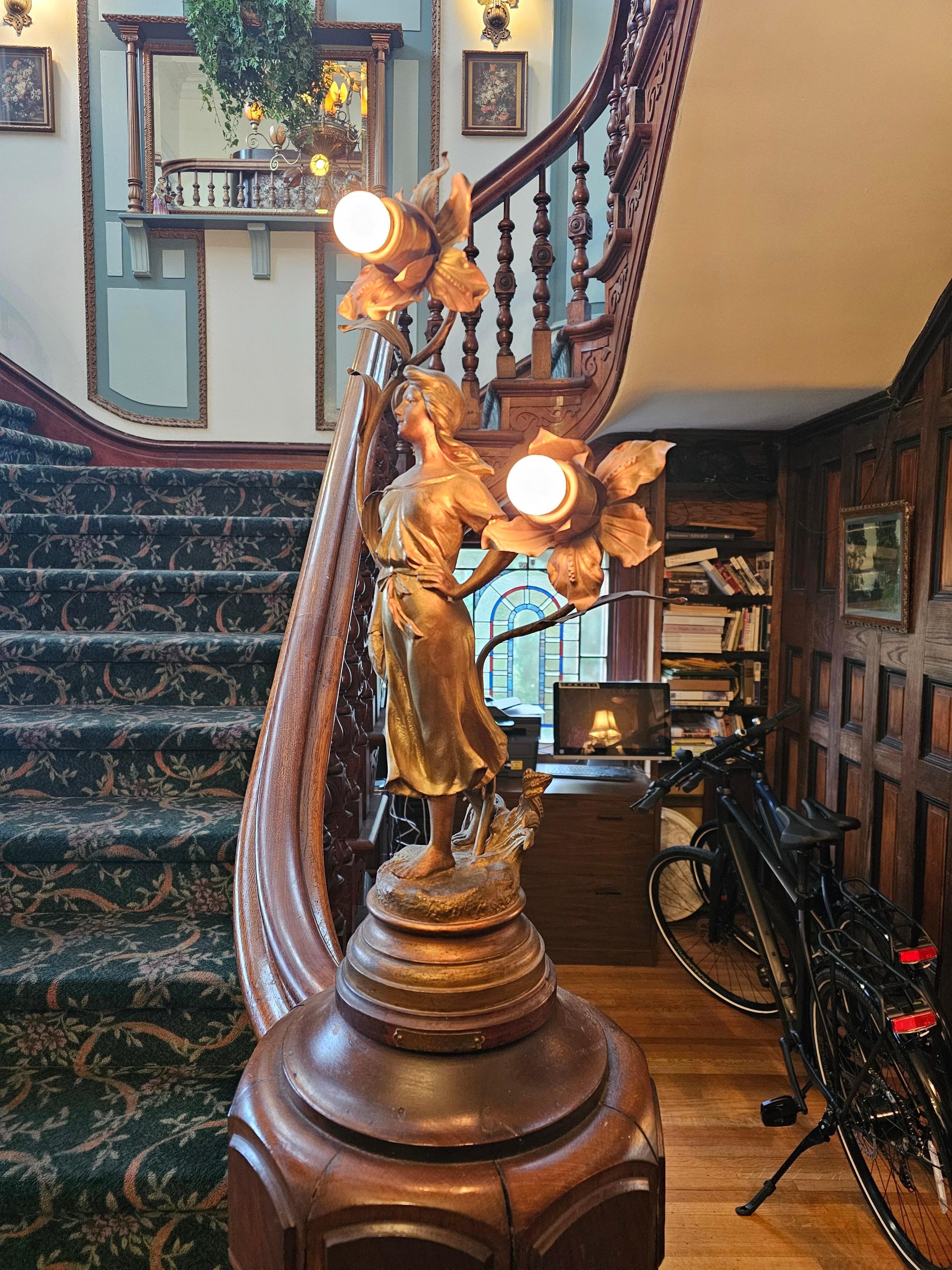 These lights on the stair rail are very unique and we have done research on them as we have one on our home.  Great to see 2 of them by the same artist.