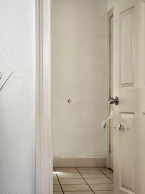 Hole in the bedroom wall from the bathroom door