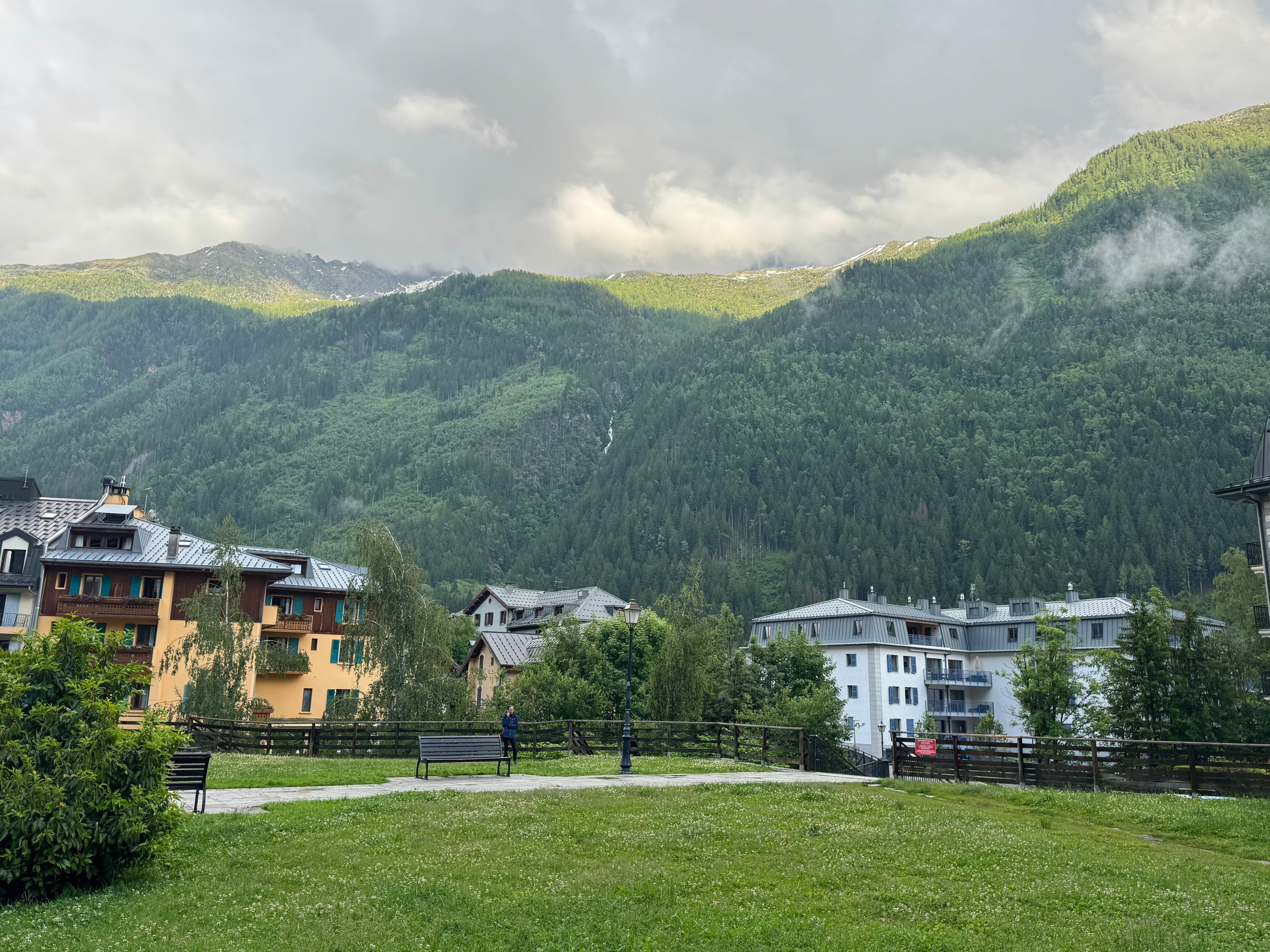 View of hotel from nearby shopping and small green area.