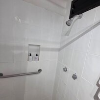 Dated Shower finishes, handles and shower head.