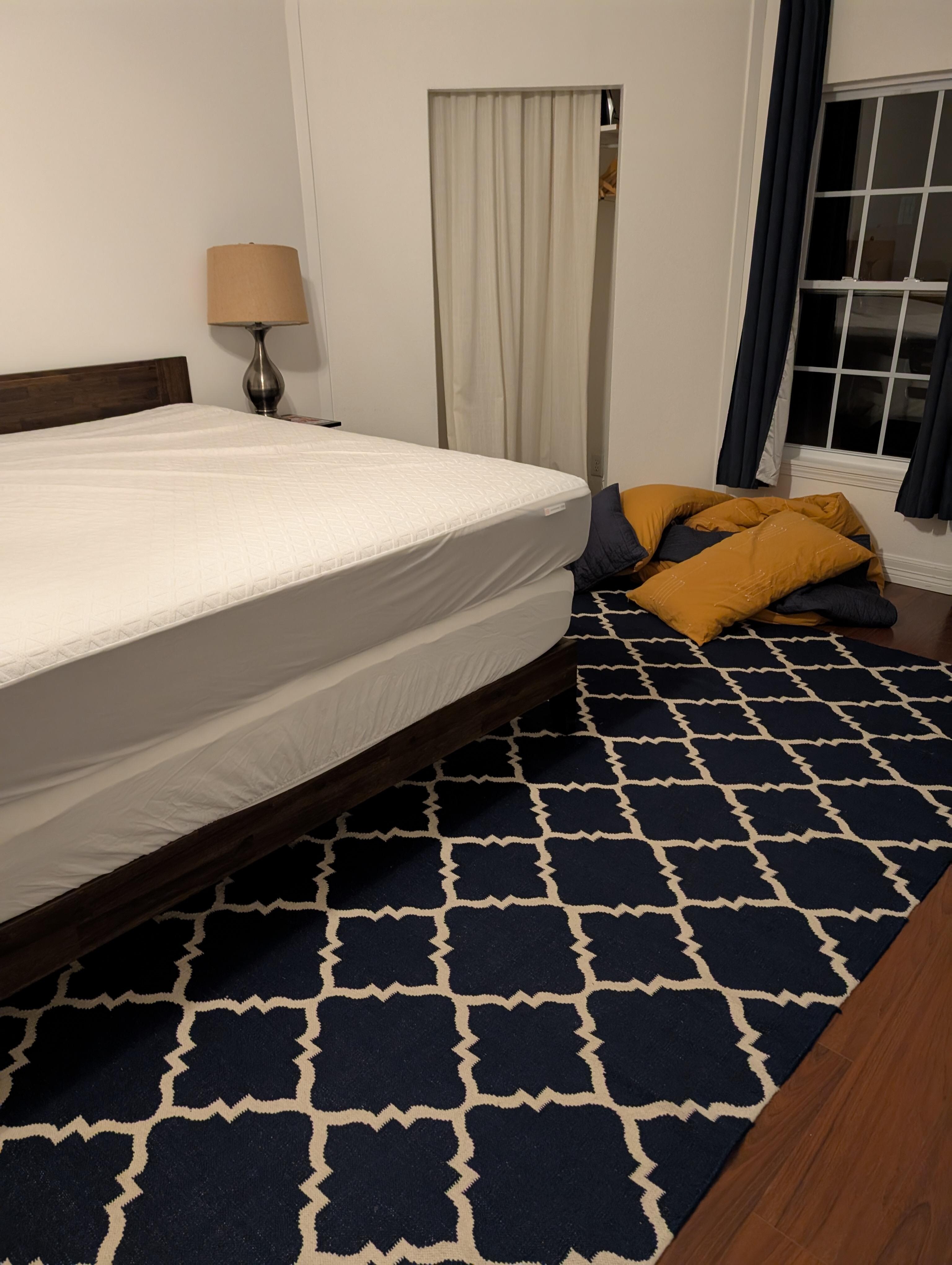 Bed wasn't made and comforter and pillows on the floor