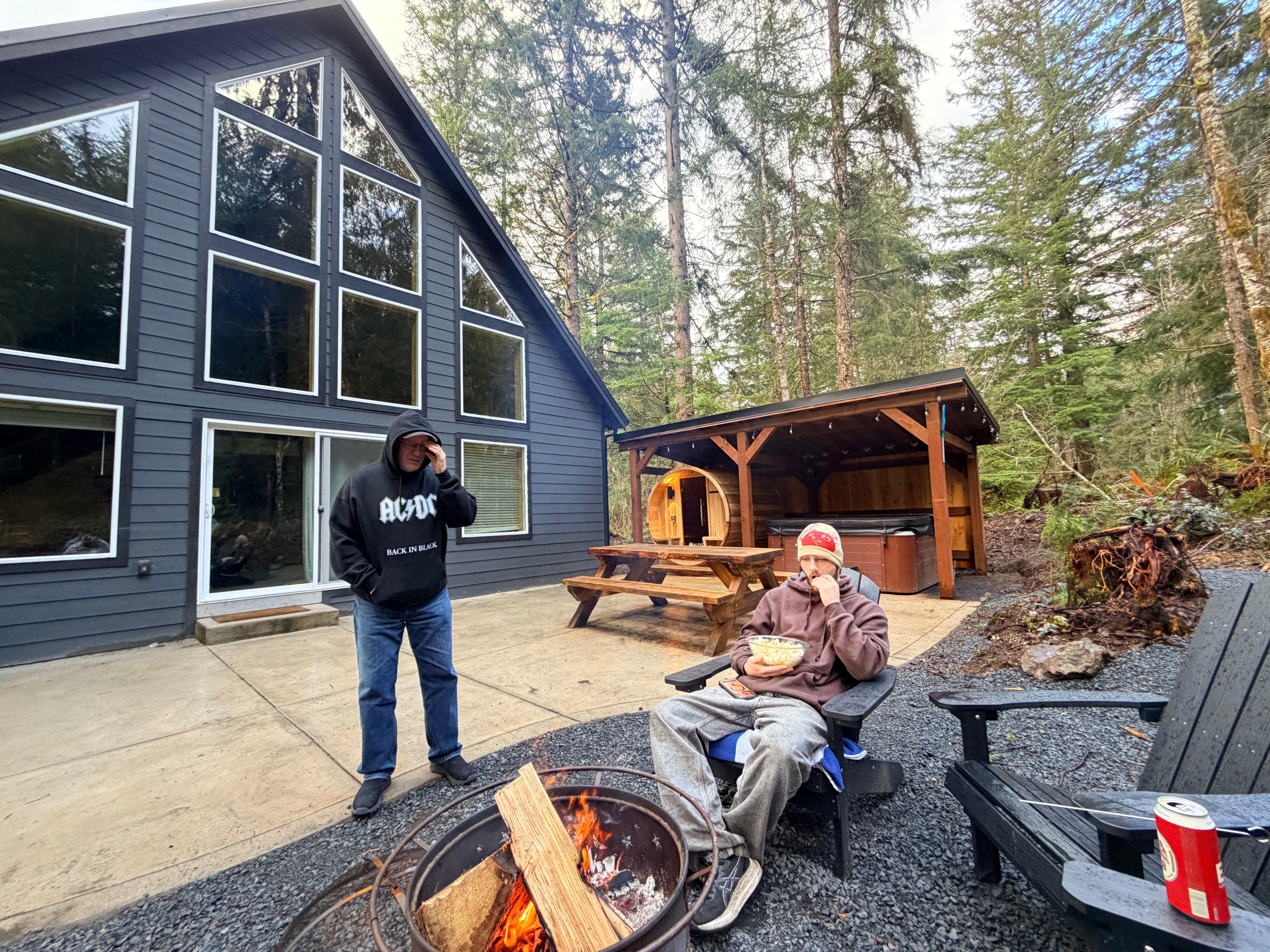 Back deck with fire pit, sauna and hot tub.