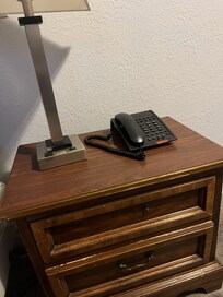 broken lamp and bedside table, phone with buttons pushed in