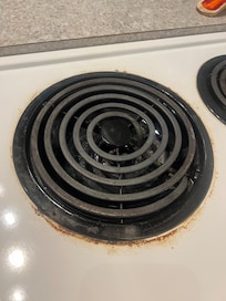 Dirty stove top even after it had been cleaned by the cleaner.