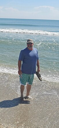 My husband walking the beach.