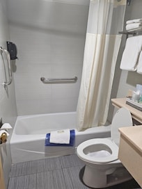 Bathroom with tub and grab bar