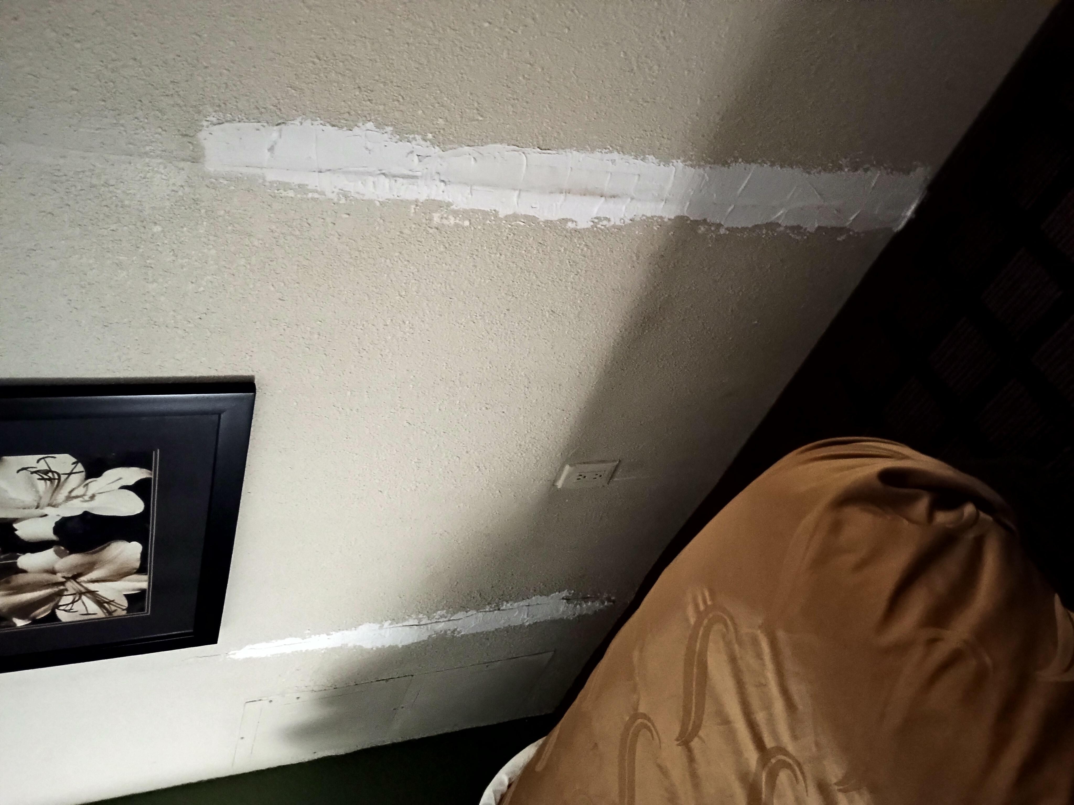 Unfinished patches on wall from a former leak