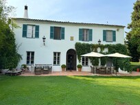 Outdoor seating areas in the garden behind the main house