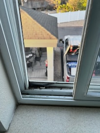 Broken window screen at bottom room 202