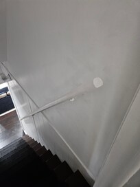 Banister is installed upside-down and is not attached firmly to wall.