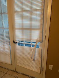 Torn blinds in master bedroom.