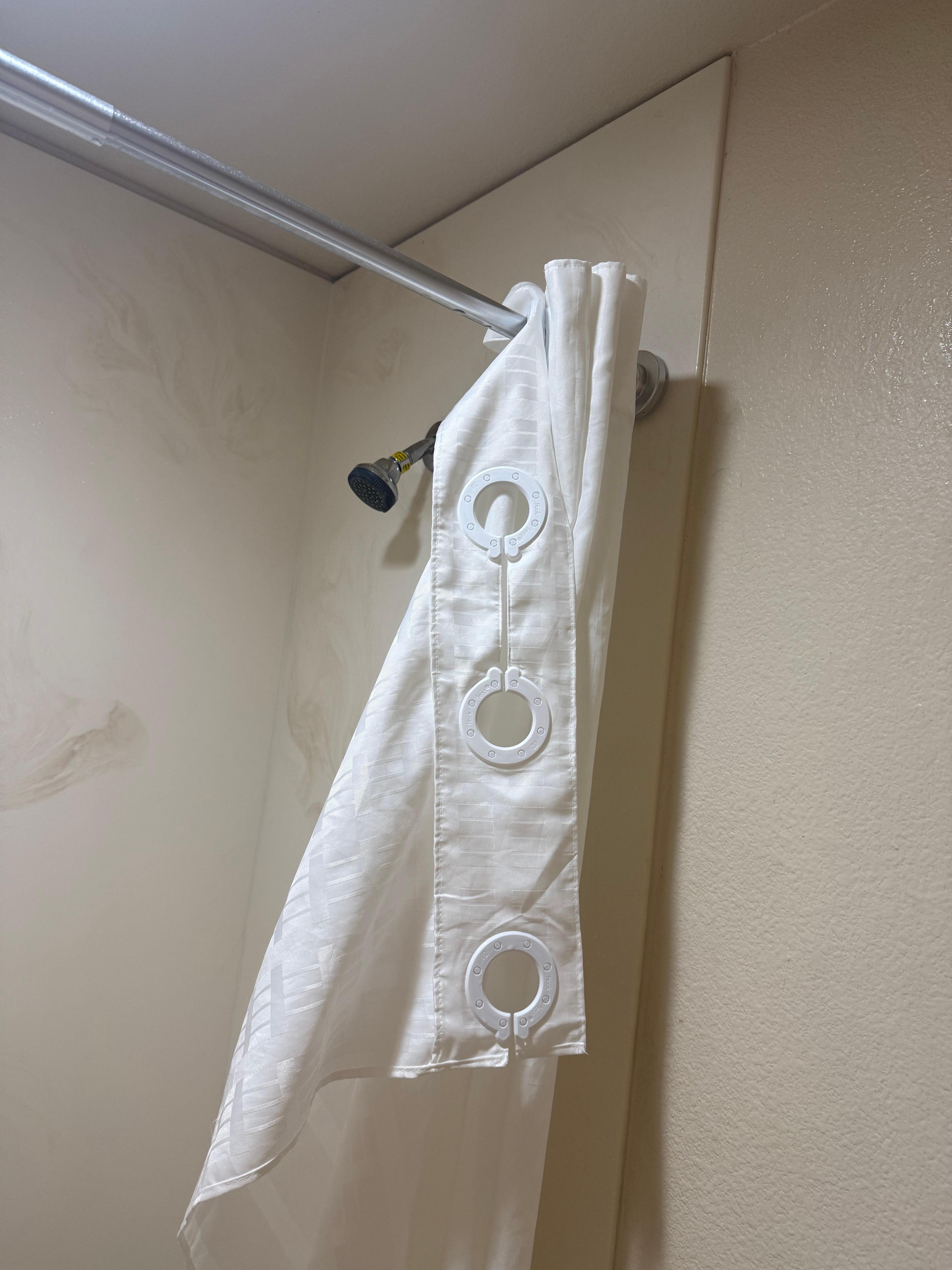 Shower curtain barley on, we fixed so we could shower with getting water everywhere 