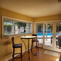Lovely inside eating area with view of beautiful gardens and well maintained pool.
