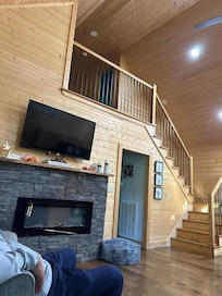 Sugar Bear Cabin view from living room to upstairs bedroom/bathroom and hall to the other three bedroom and bathroom.