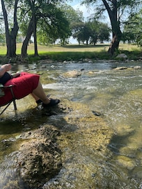 Sitting in the river with our chairs.