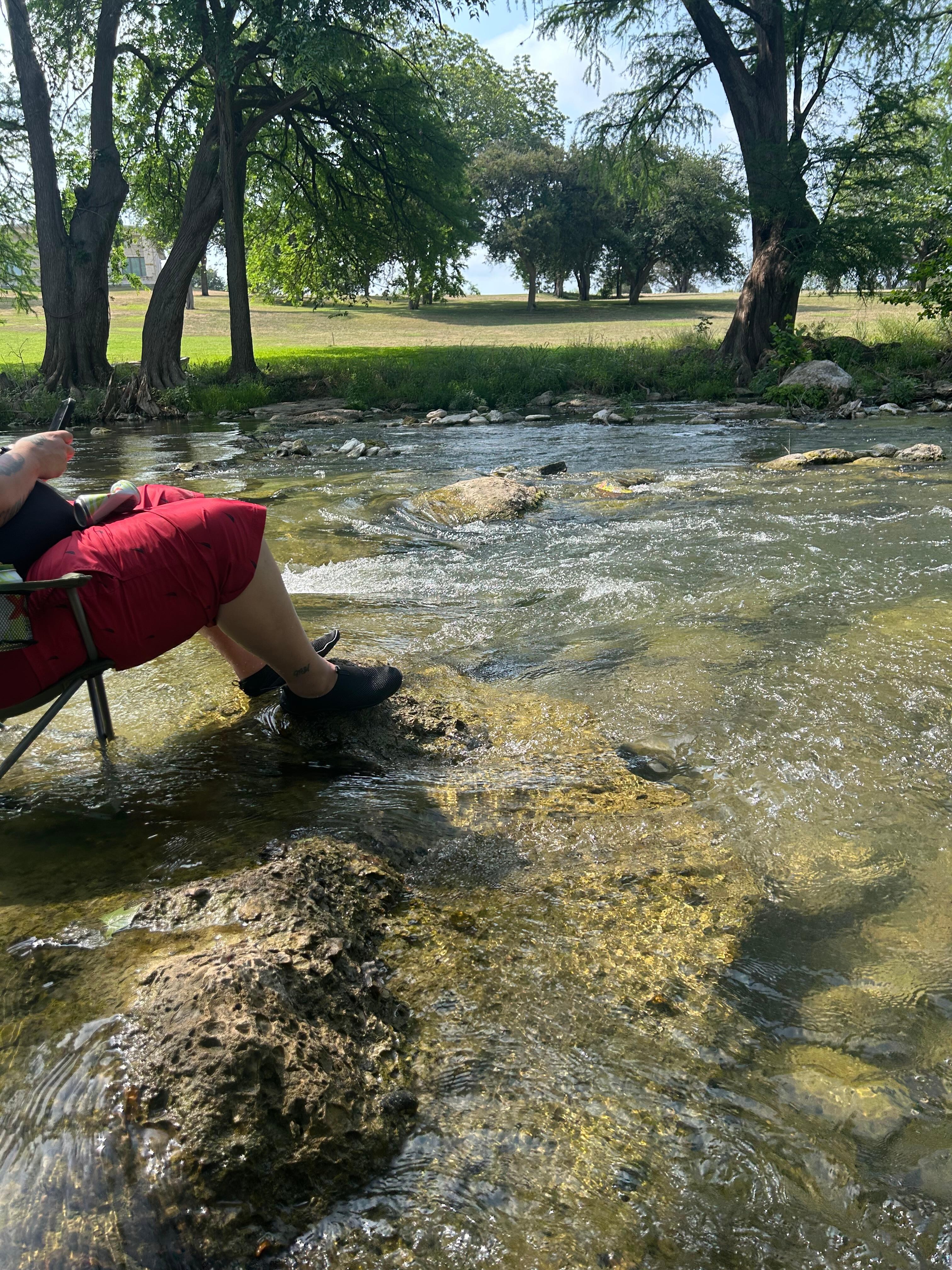 Sitting in the river with our chairs.