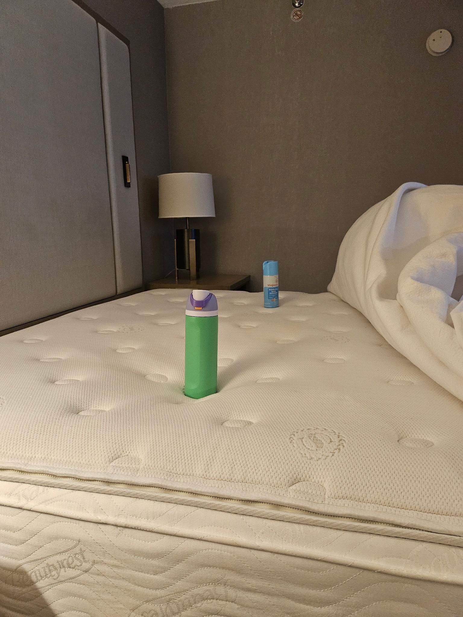 You can see how the water bottle is down in the hole and the Lysol bottle is sitting up higher.