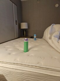 You can see how the water bottle is down in the hole and the Lysol bottle is sitting up higher.