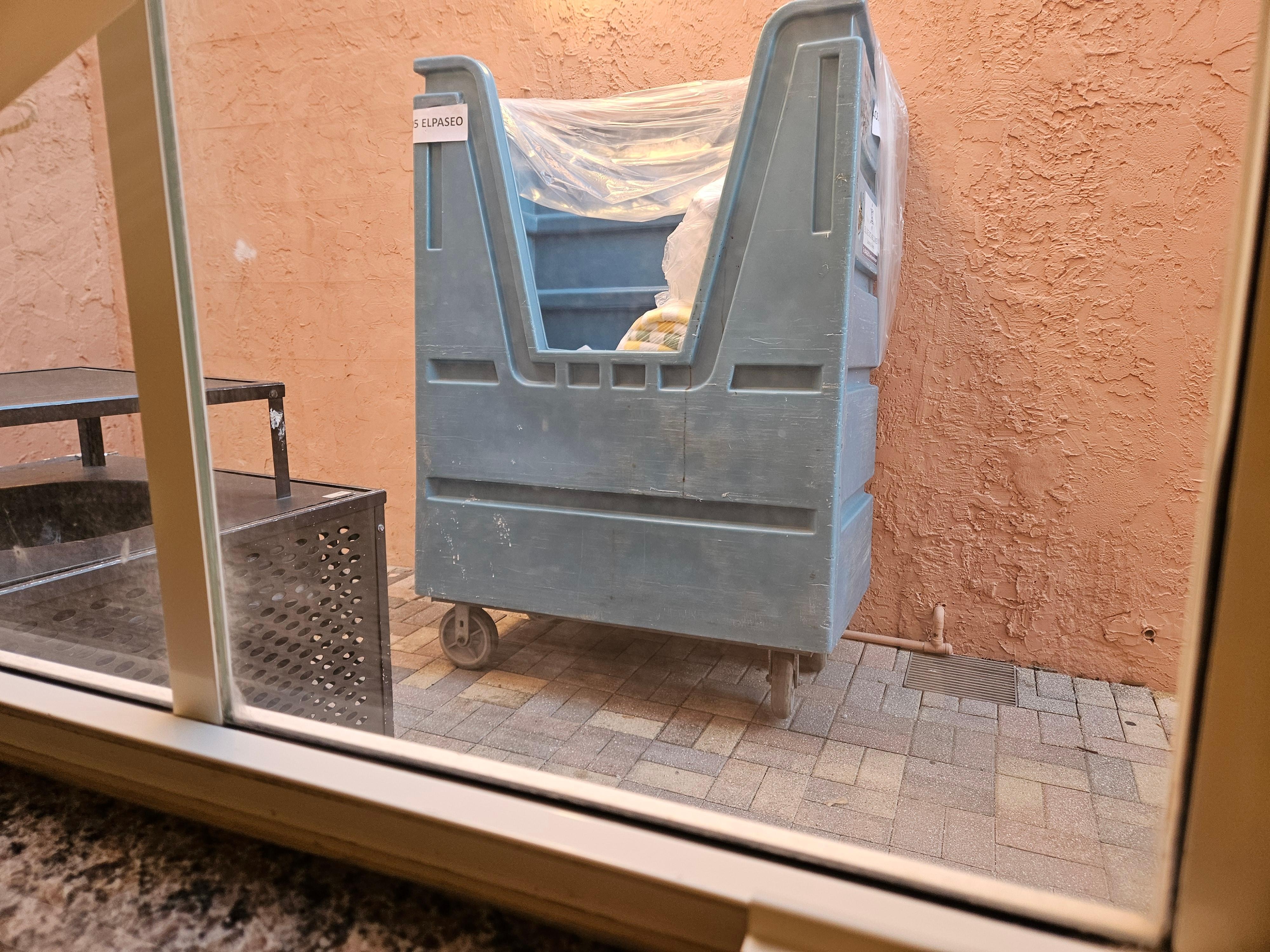 View from my room - a wall and a trash can.