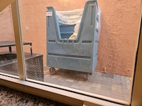 View from my room - a wall and a trash can.