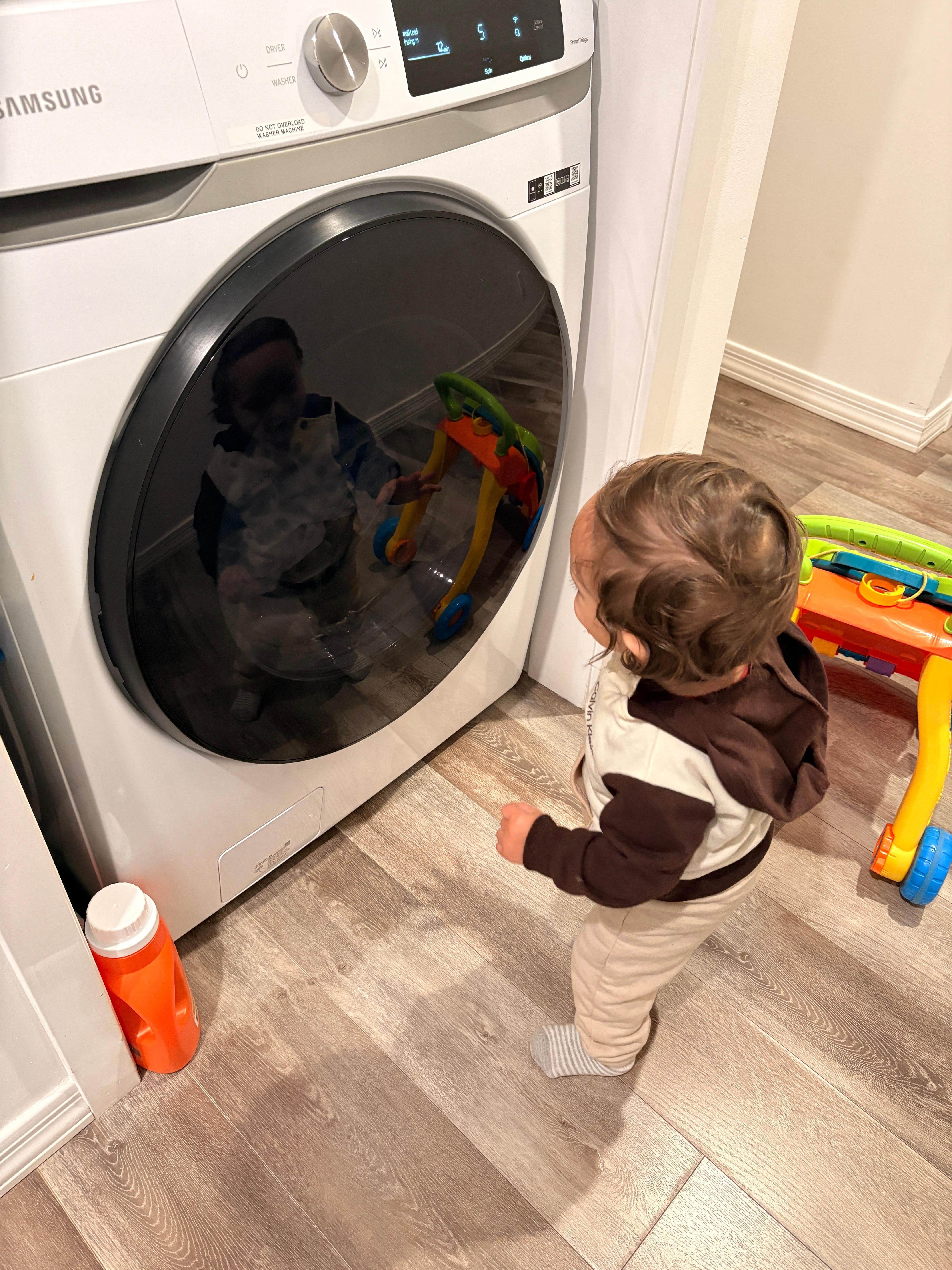 My grandson is fascinated by the dryer. 