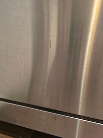 Food splashed on the dishwasher that was not cleaned.