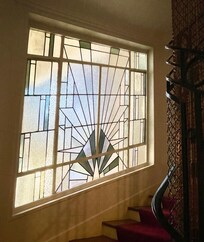 Deco windows and classy carpeting in the building’s hallway.