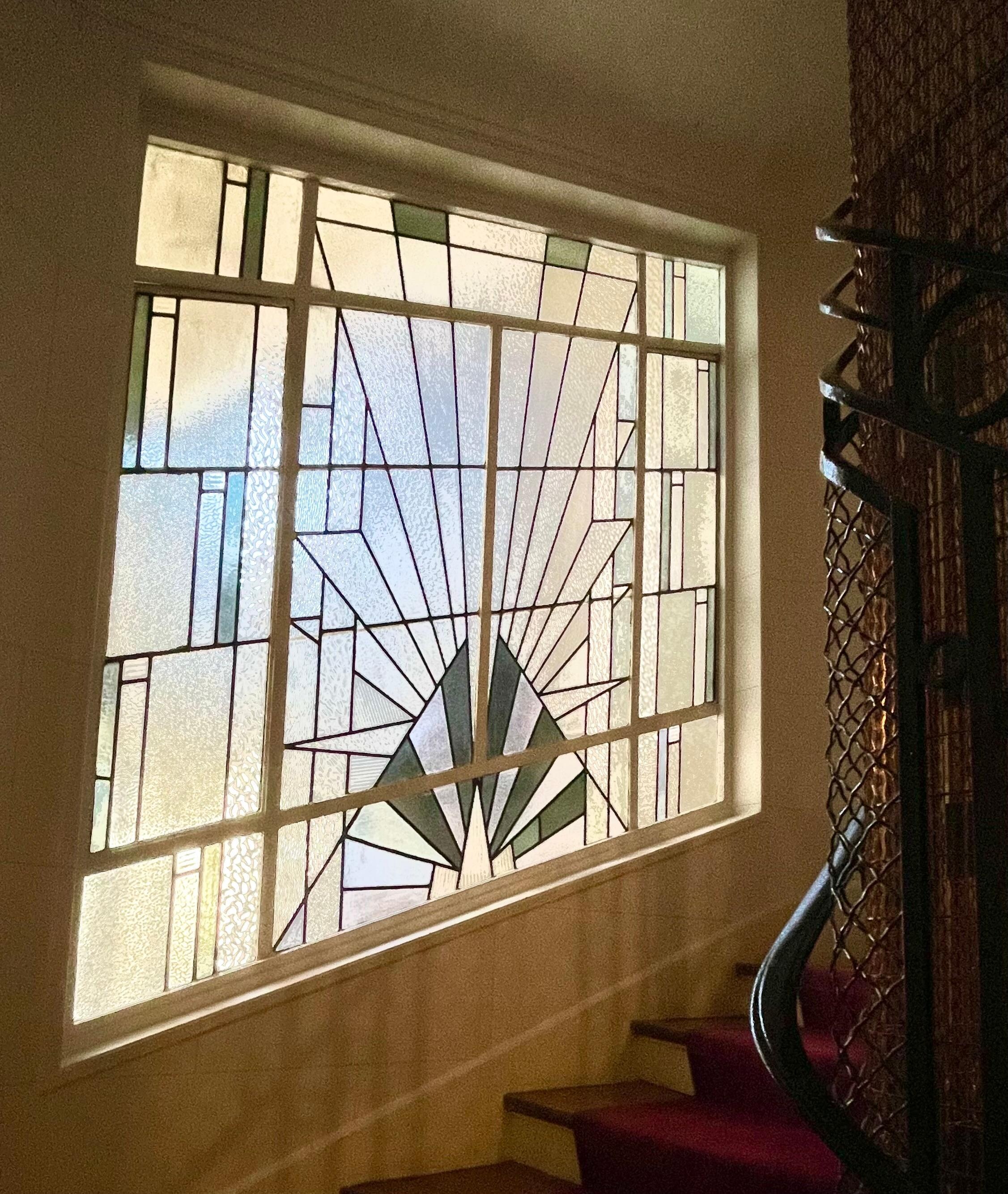 Deco windows and classy carpeting in the building’s hallway. 