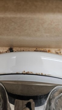 Behind the sink it was filthy eyelashes behind the sink I didn't take pictures of the bathroom but it had hair in there