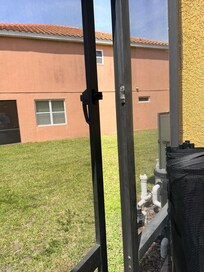Broken door from the pool area to outside.
