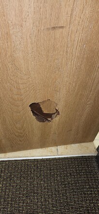 Hole from door being kicked in.