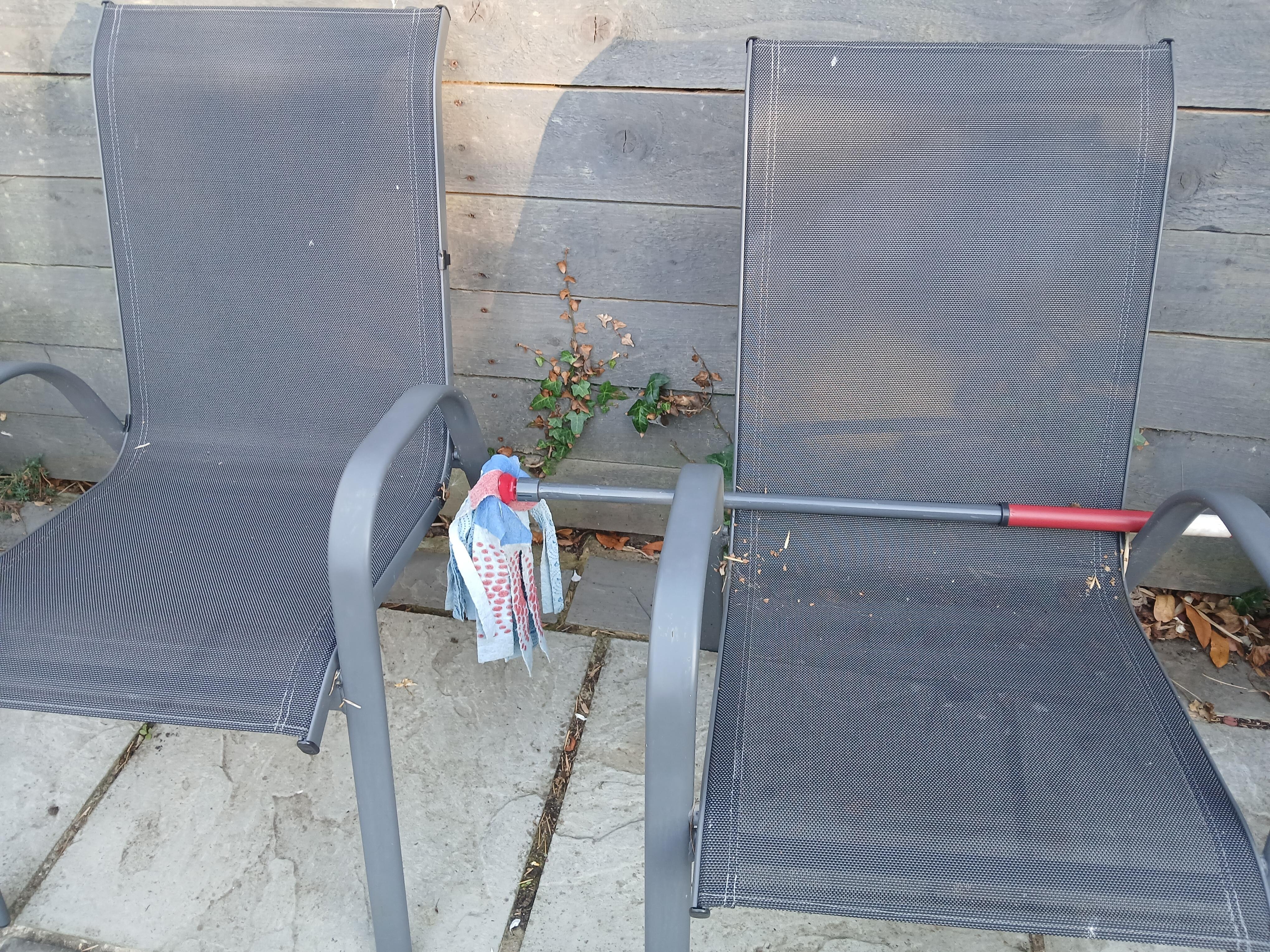 Mop left across garden furniture 