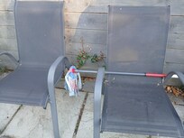 Mop left across garden furniture