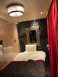 The room. There is a bath by the door.