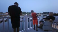 the boys fishing off the balcony