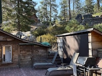 Back deck shown with non functional bbq and hose not put away