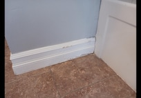 Rotting baseboard in the bathroom