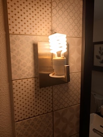 In the bathroom. Larger size insect that was dried up from light in clear view, very noticeable. Should have been noticed by staff when cleaning.