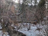 Lots of brush blocking the house. But we got another angle.