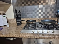 Microwave, 12 cup coffee pot, and cookware.