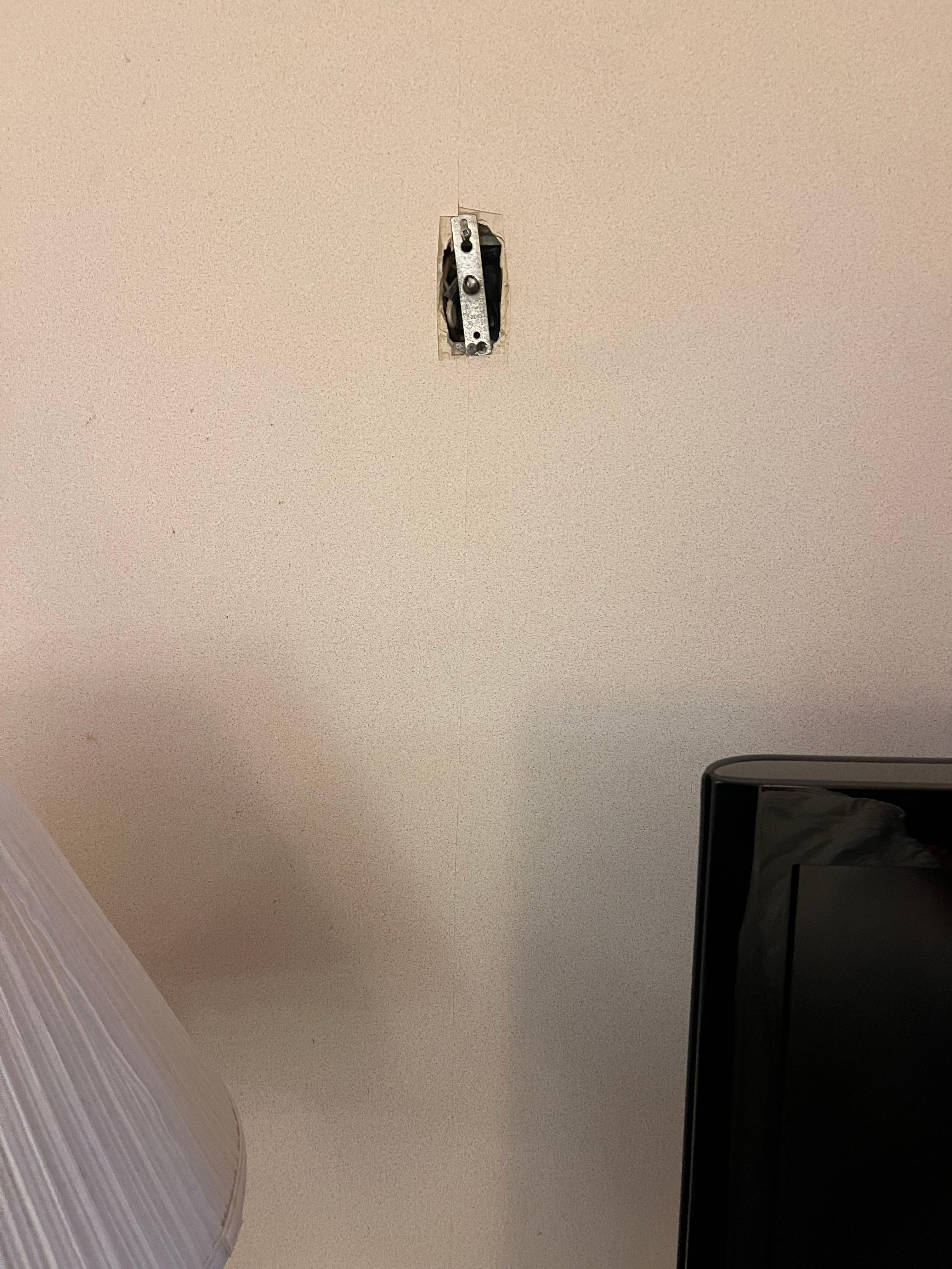 Random hole in the wall was covered by a small metal piece that looked out of place.