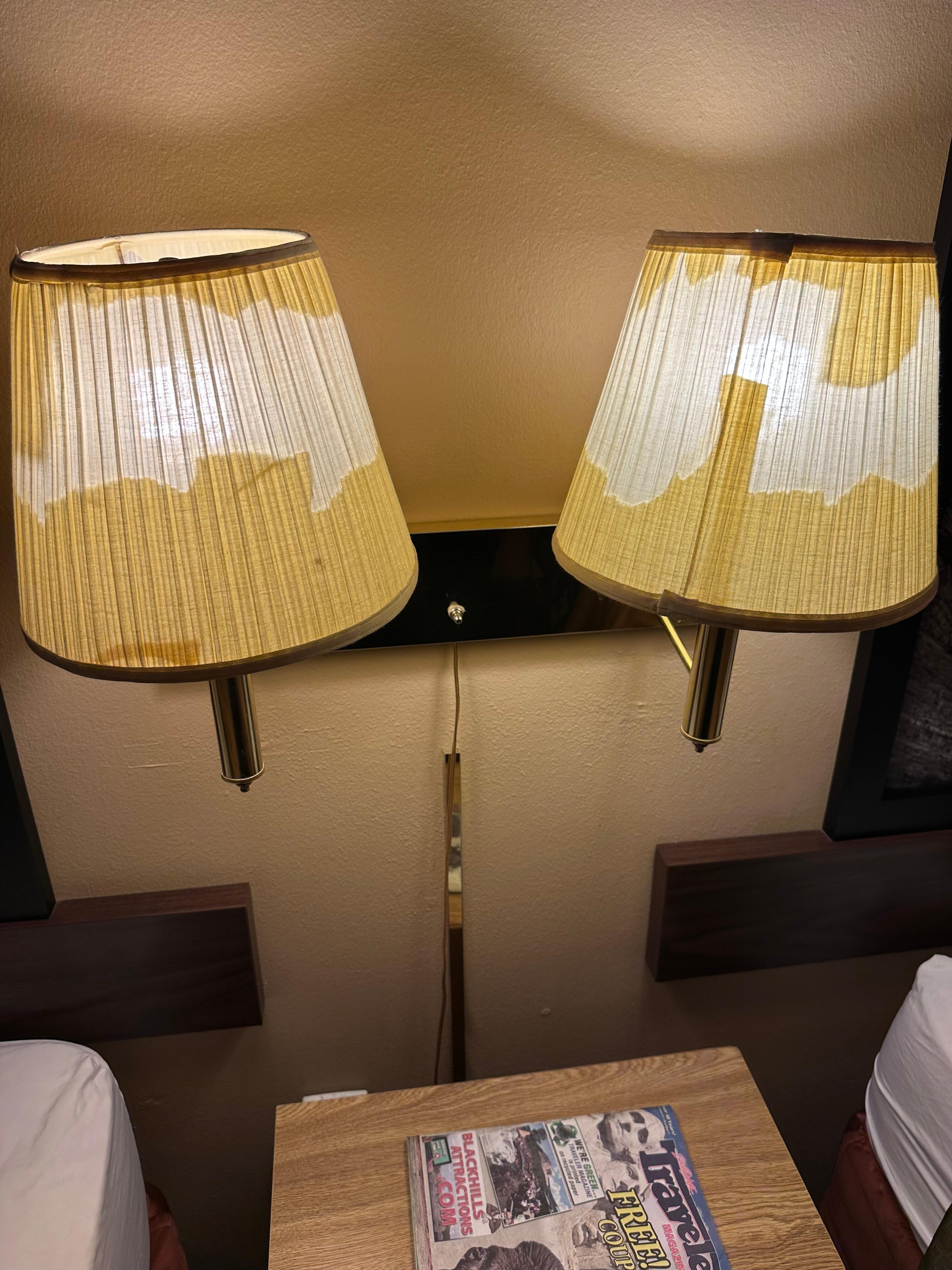 The flakes of the shades was still on the ground and behind the bed.
