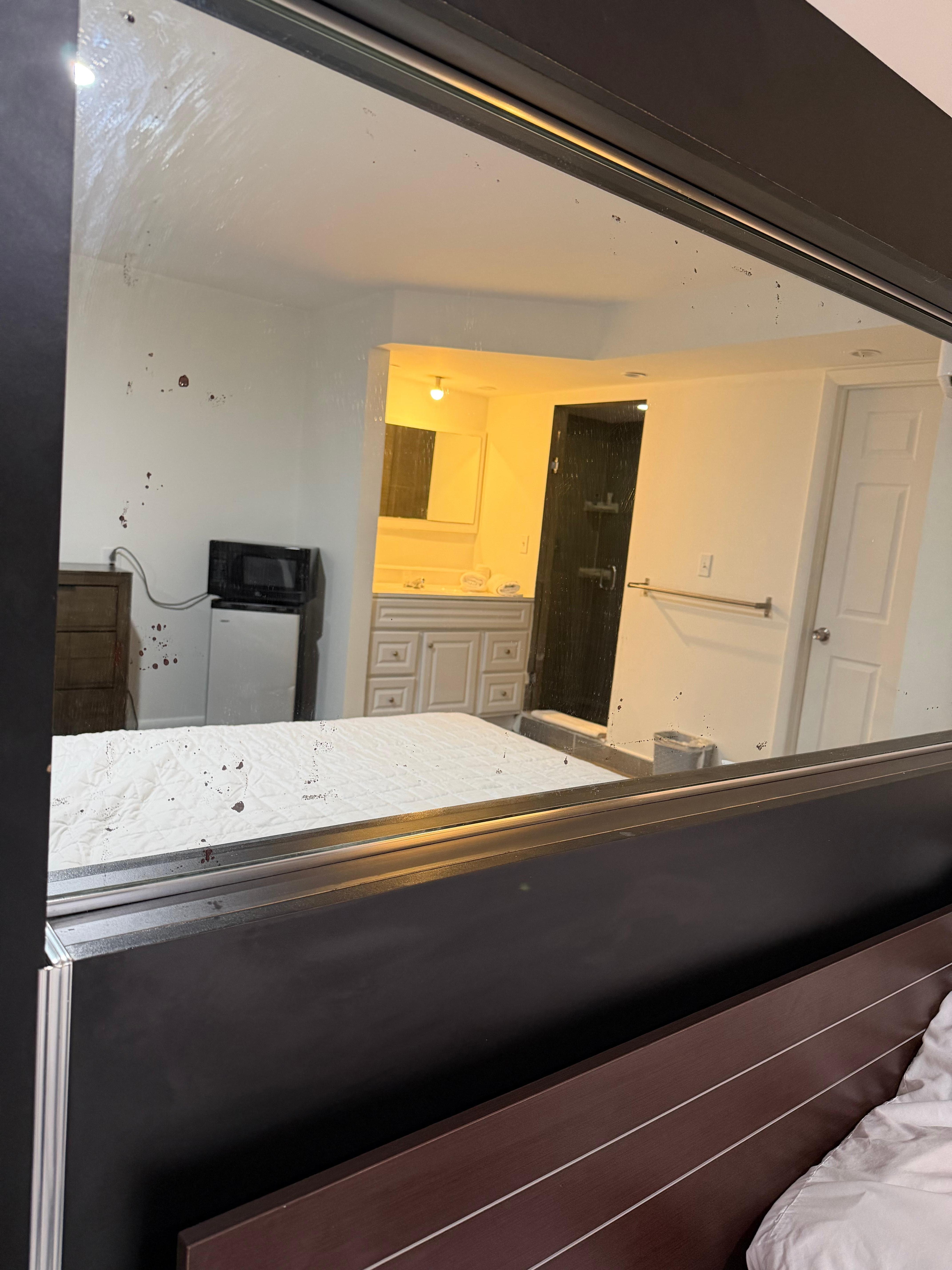 Dirty mirror with unknown stains covering it